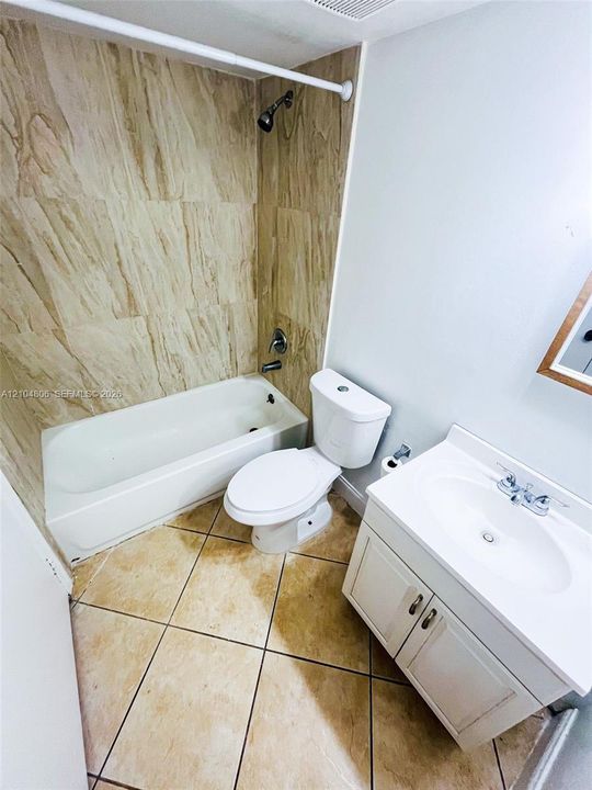 White vanity with integrated sink, chrome faucet, and cabinet storage