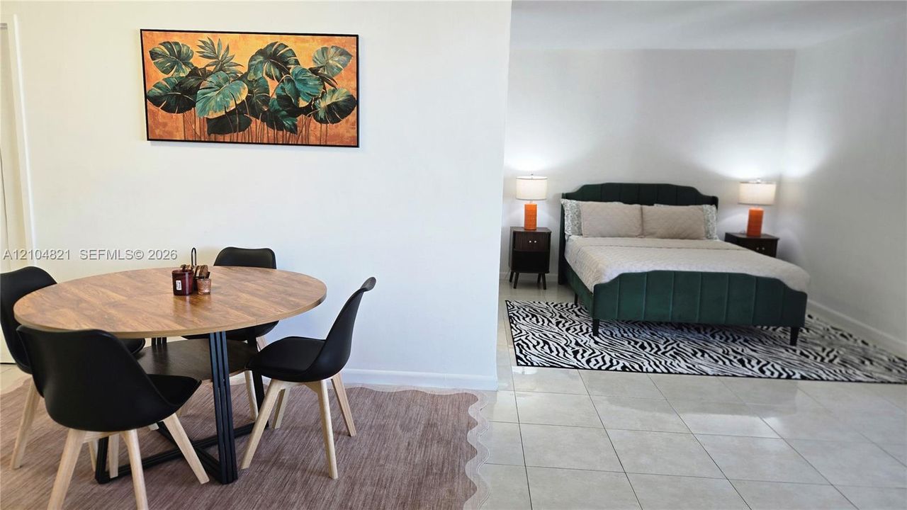 Tile flooring, wood-finish flooring, and crisp white walls provide a neutral backdrop