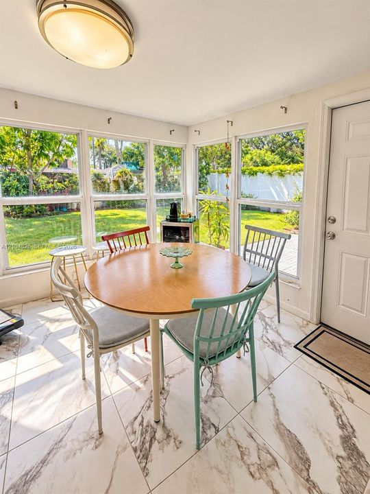 Room featuring large windows, white walls, and a ceiling-mounted light fixture