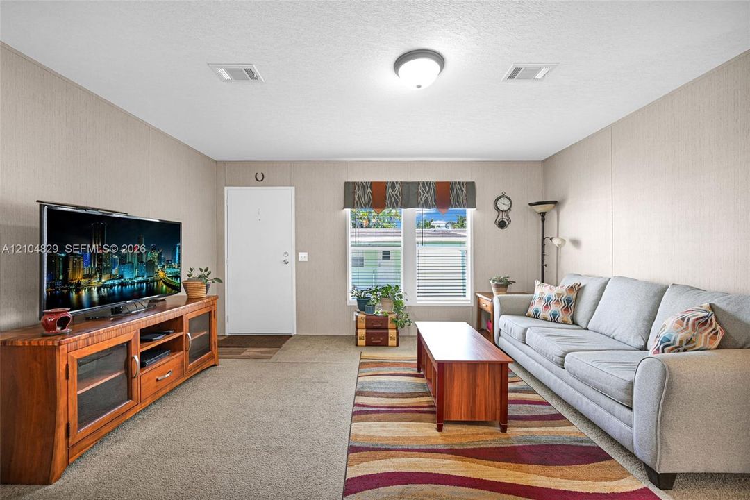 Neutral wall finishes, carpeting, and flush-mount ceiling lighting
