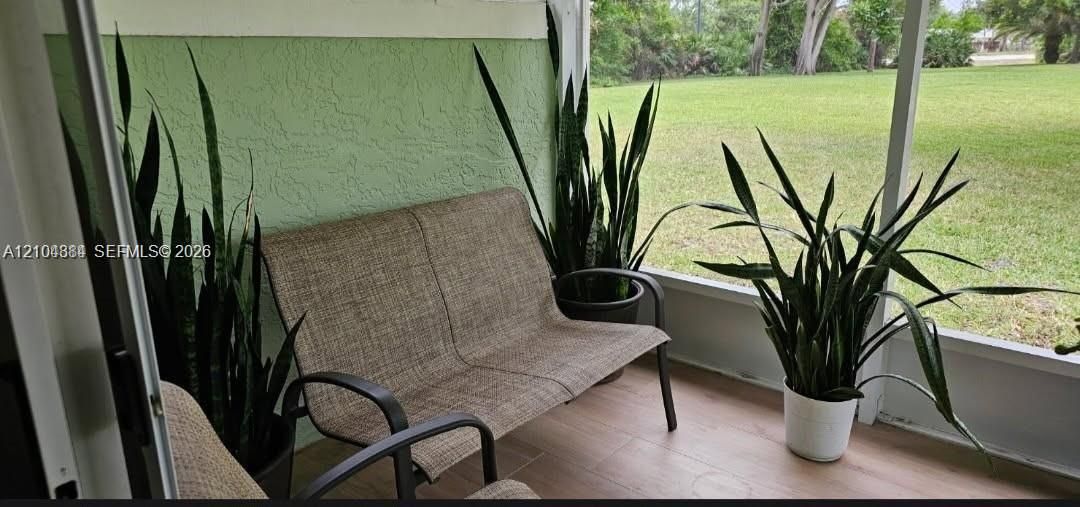 Screened patio with wood-finish flooring
