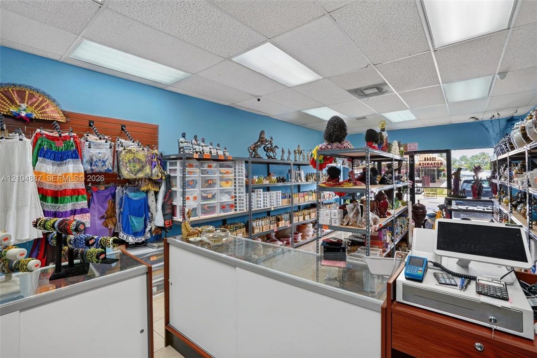 Commercial interior featuring a drop ceiling with recessed lighting, high-visibility storefront glass, durable tile flooring, and built-in service counters