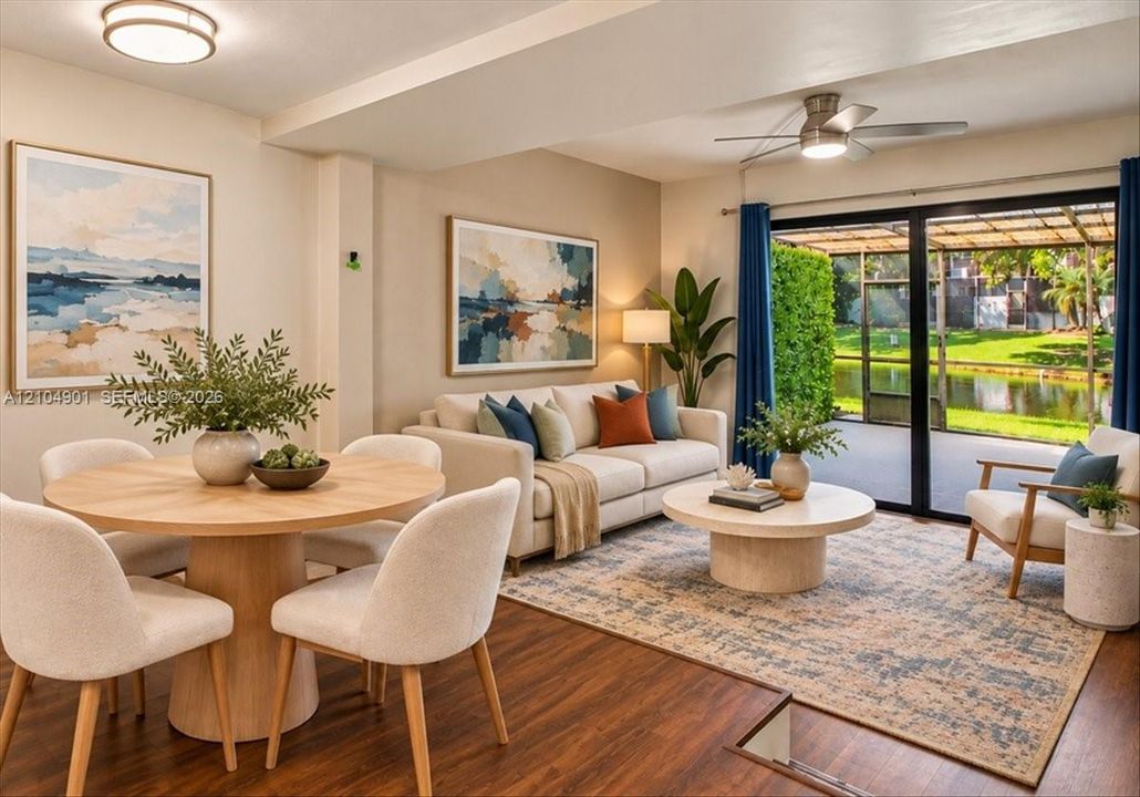 Open-concept living space featuring wood-finish flooring, recessed lighting, a modern ceiling fan, and sliding glass doors with access to a screened lanai and pond