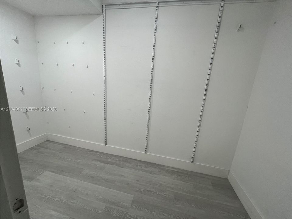 Primary bedroom walk in closet