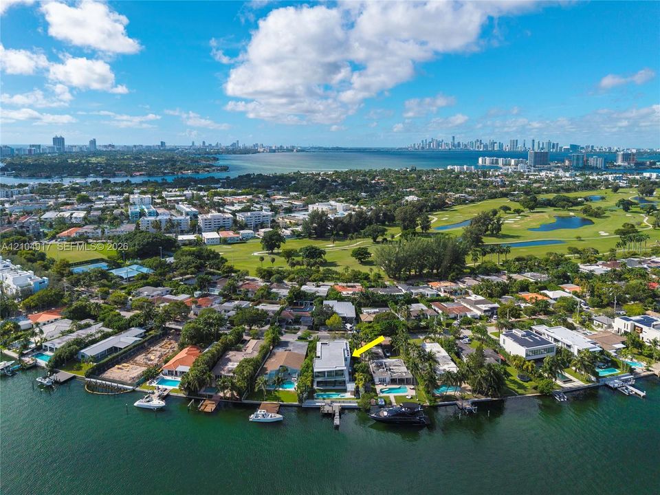 Waterfront residence featuring a private boat dock, swimming pool, multi-level terraces, and modern architectural design