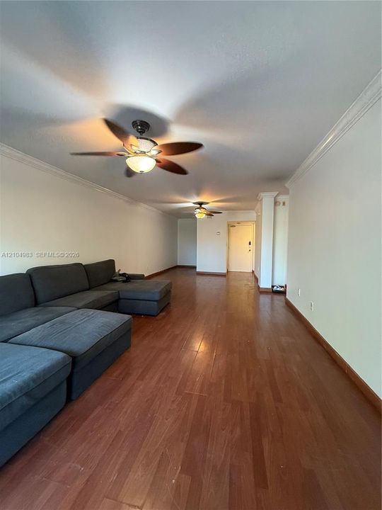 Wood-finish flooring, crown molding, and dual ceiling fans