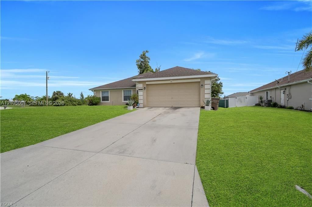Single-story residence featuring a concrete driveway, attached garage, and a shingle roof