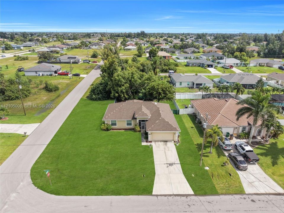 Single-story residence with an attached garage, featuring a shingle roof and a paved driveway