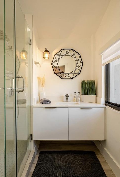 Floating vanity with concealed hardware, quartz countertop, and undermount sink
