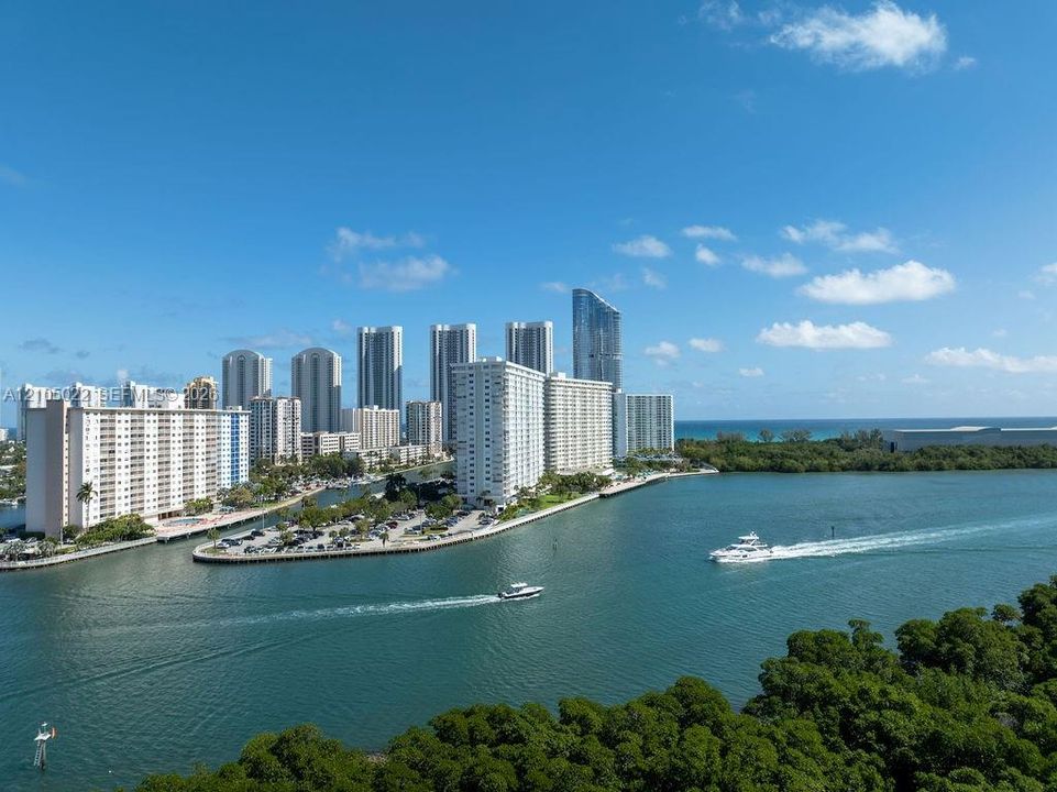 Waterfront city setting with numerous high-rise buildings and ample green space