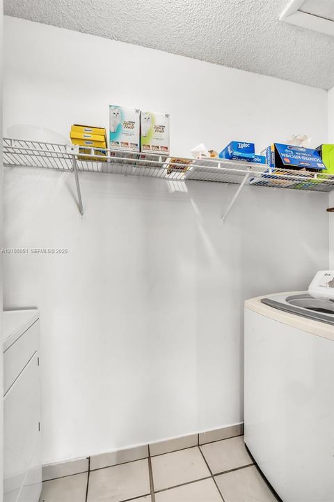 Laundry area featuring wall-mounted wire shelving