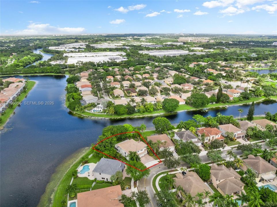 Aerial perspective of this premium waterfront lot featuring mature landscaping to be truly appreciated