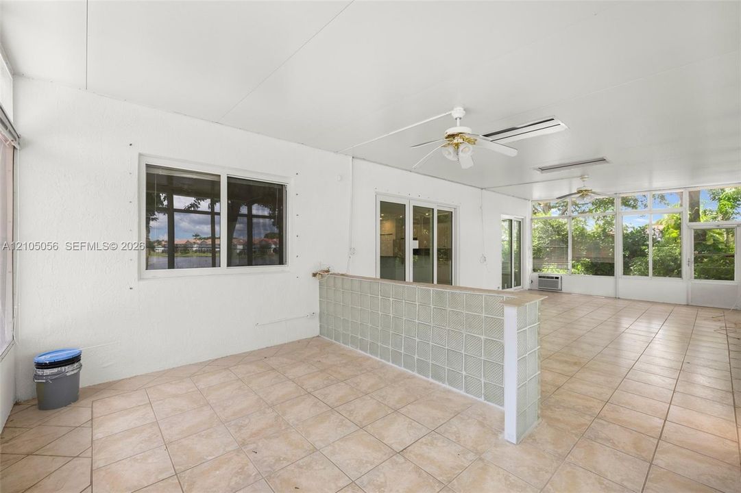 Enclosed patio featuring expansive windows