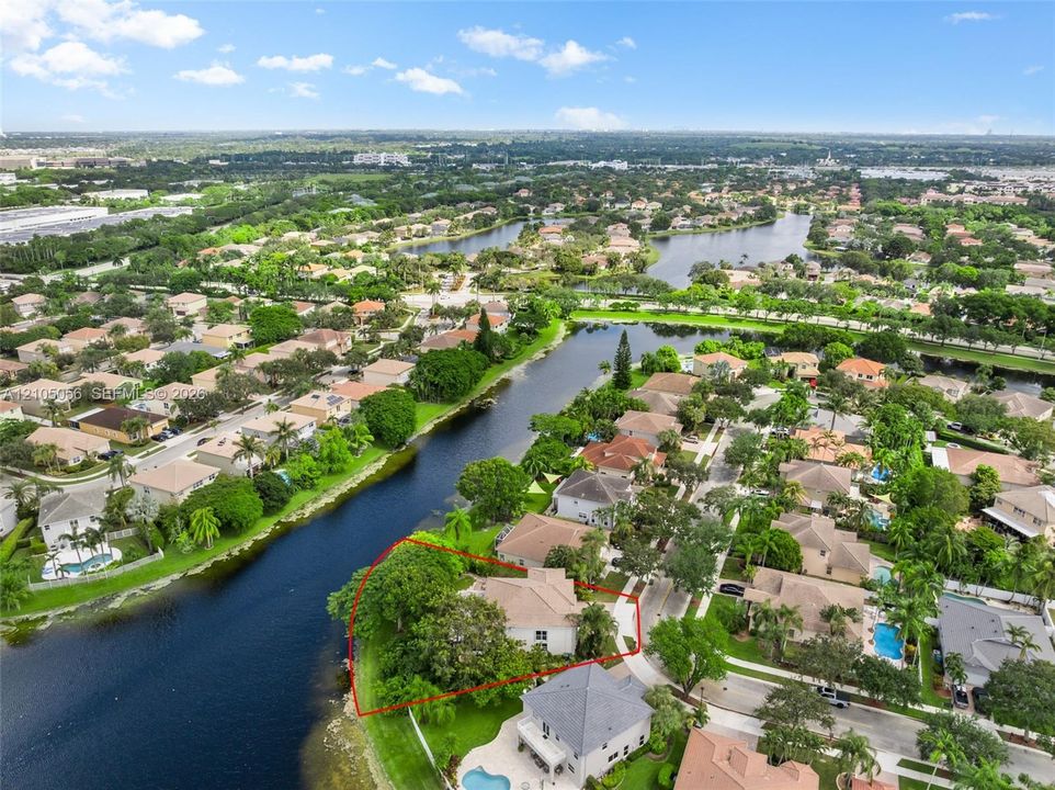 Another Aerial perspective of a this superb residential property featuring a the best waterfront location, expansive lot, and mature landscaping