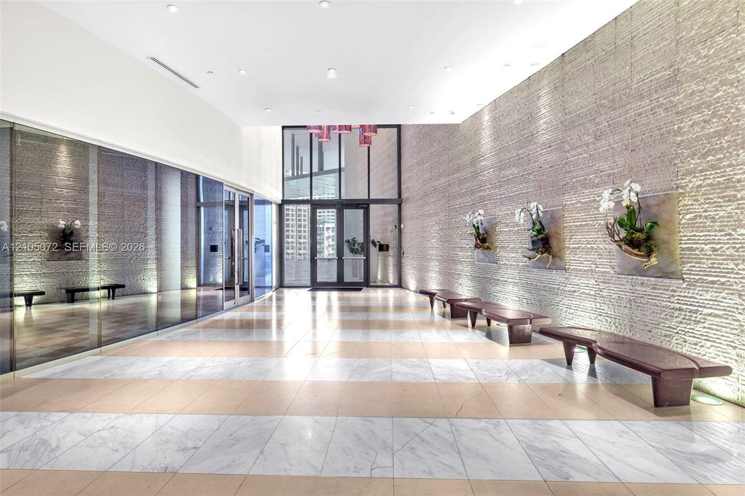 Epic Residences lobby with stone-clad walls and bench seating.