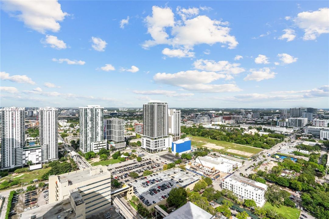 Elevated urban perspective featuring a metropolitan cityscape, high-rise architecture, and expansive horizon
