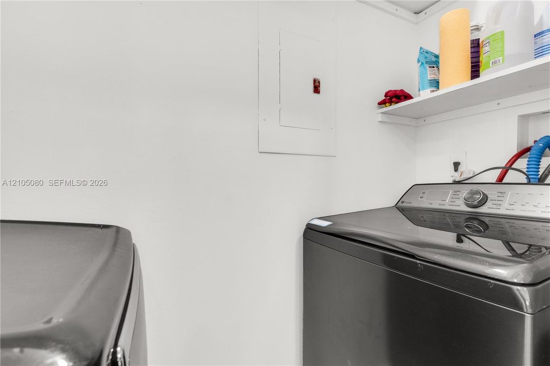 Wall-mounted shelving unit and built-in electrical service panel