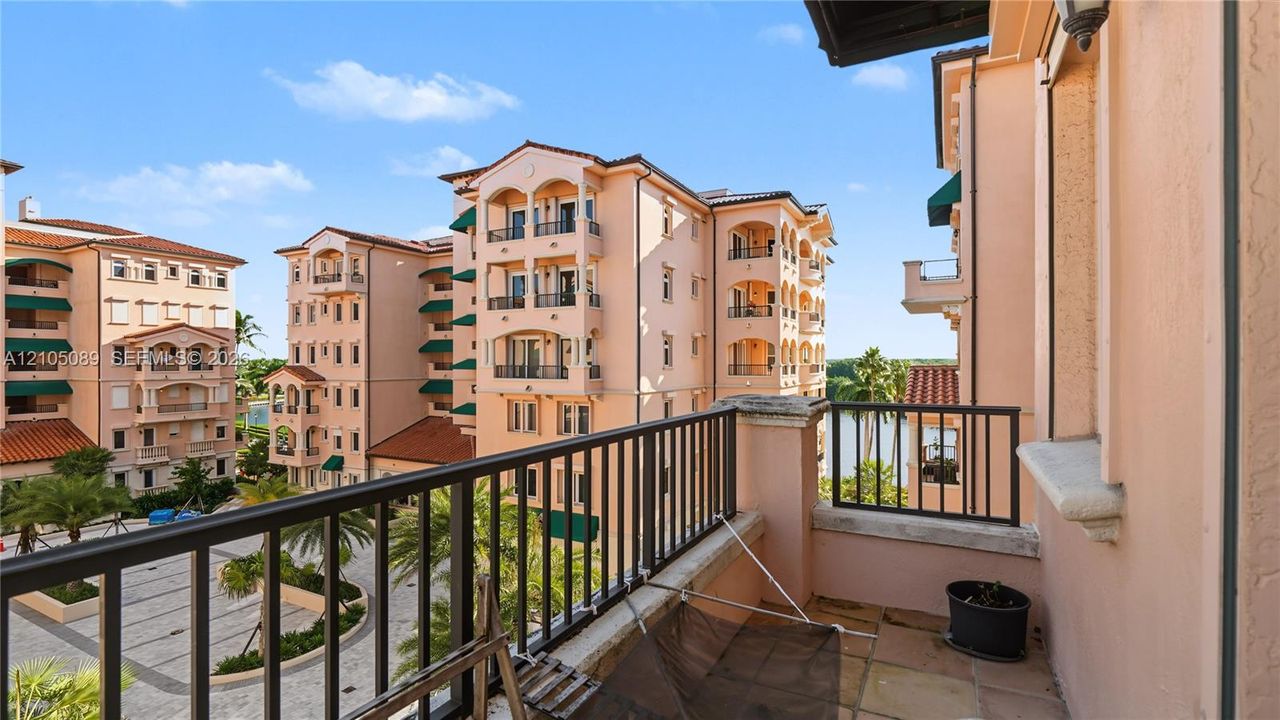 Private balcony featuring stone-finish flooring and black metal railing