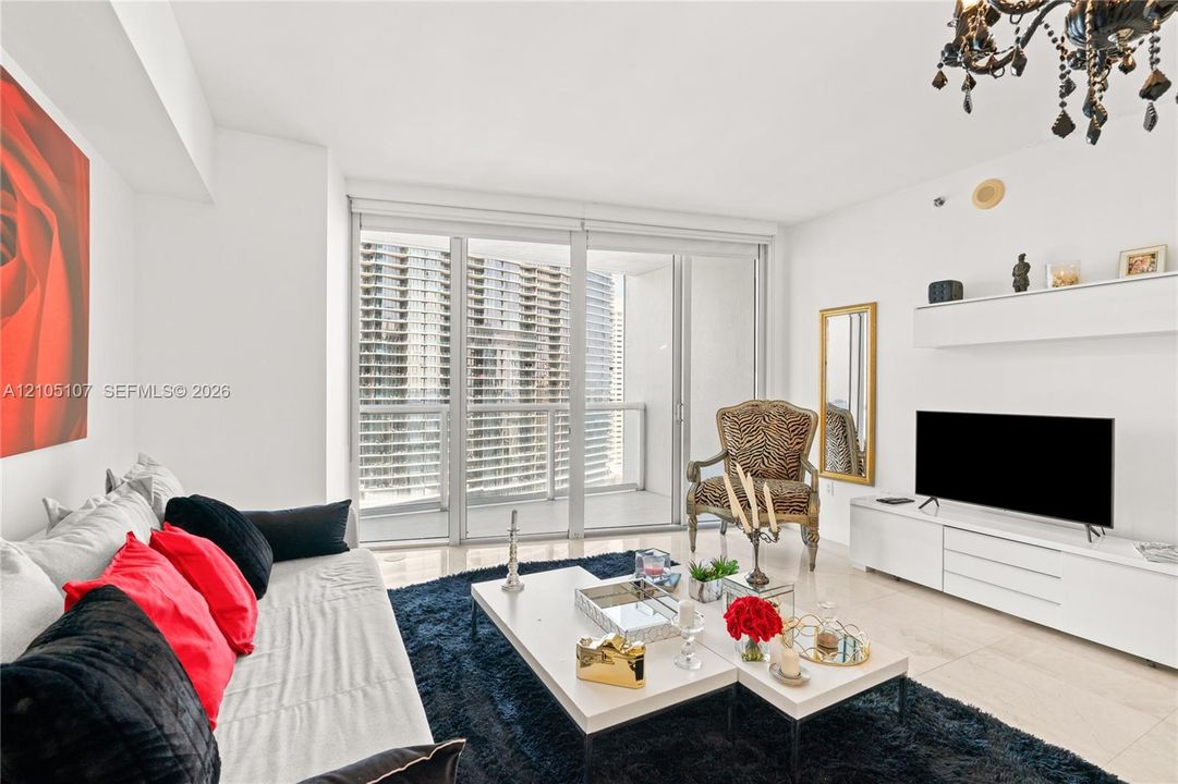 Tile flooring, full-height sliding glass doors, built-in wall shelving, and an ornate ceiling-mounted light fixture