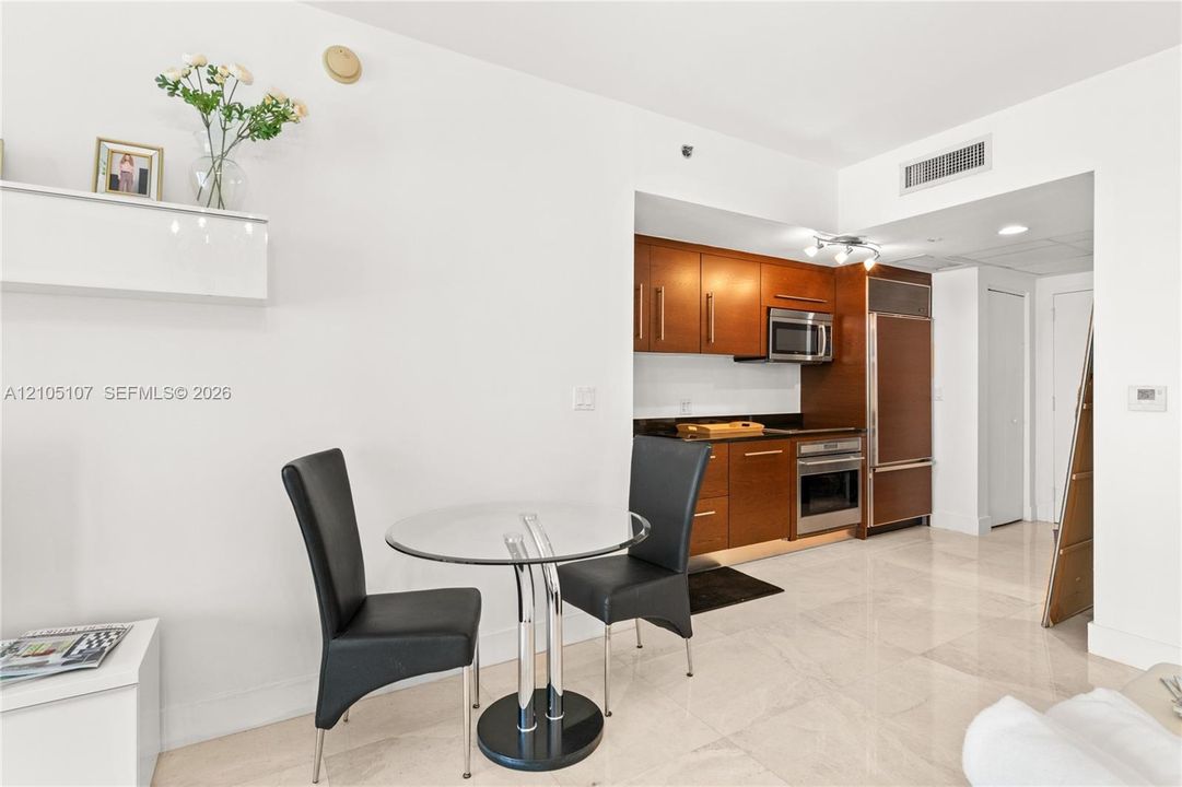 Kitchen featuring wood cabinetry, stainless steel appliances, and dark countertops