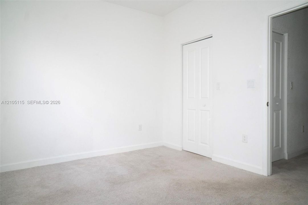 Neutral interior featuring wall-to-wall carpeting and interior panel doors