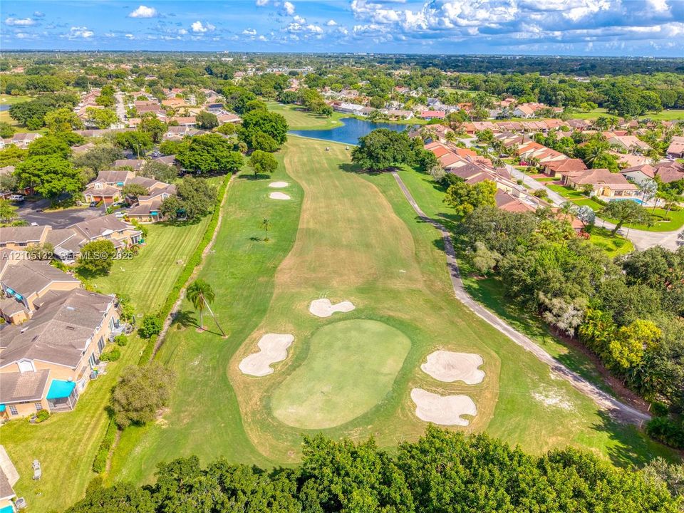 Expansive golf course frontage with multiple sand traps and a putting green