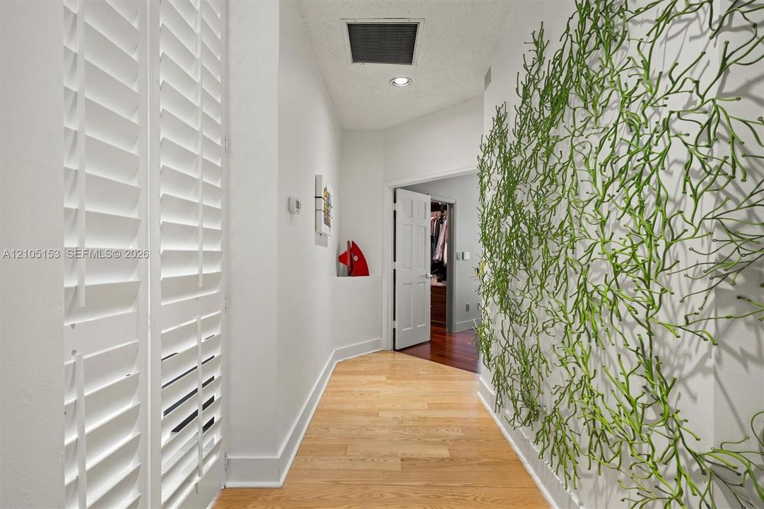 Hardwood flooring throughout, white plantation shutters, recessed lighting, and white trim
