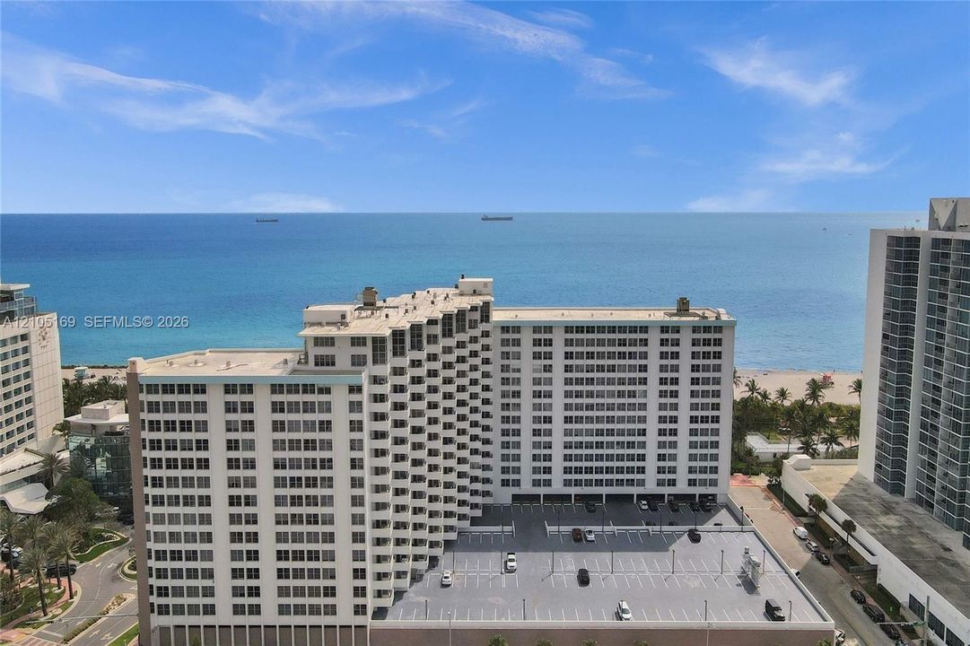 Oceanfront high-rise building featuring a multi-story parking structure