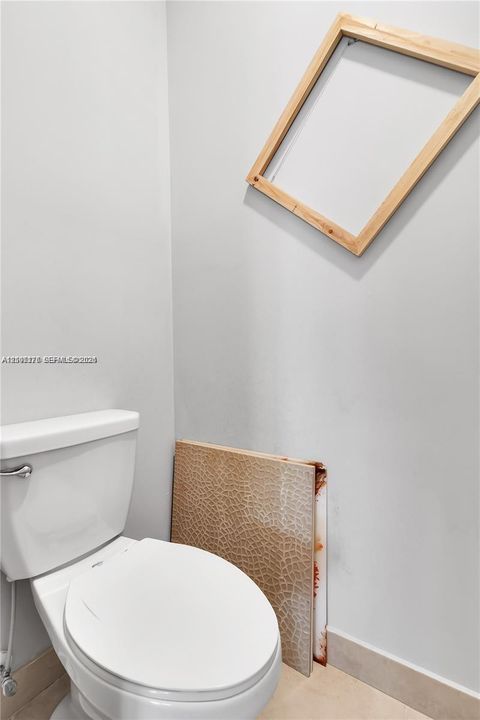White vitreous china toilet featuring a dual-flush actuator