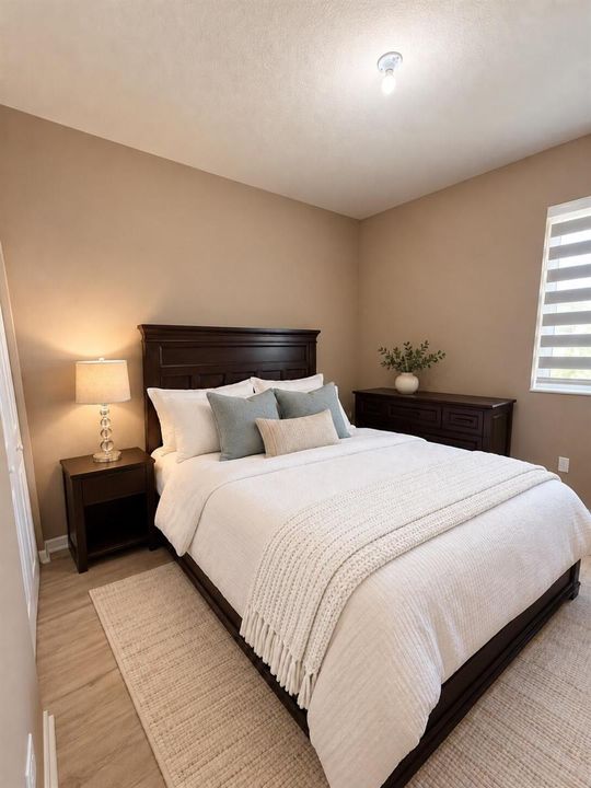 White throw, seamless taupe bedroom wall