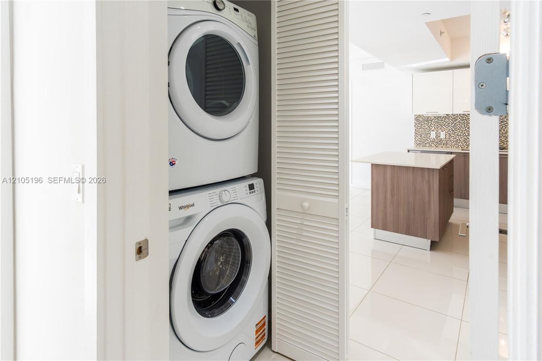 Stackable washer and dryer appliances within a louvered bifold door enclosure