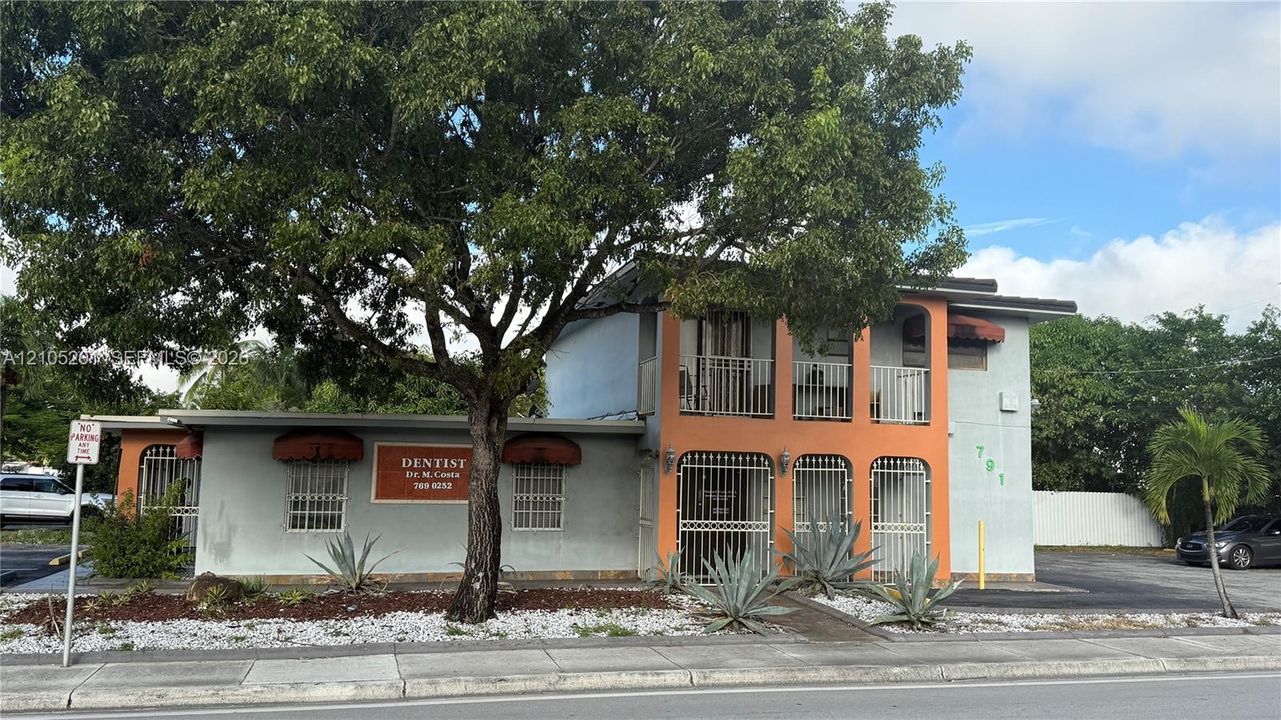 Two-story commercial building with an exterior staircase and multiple entrance points