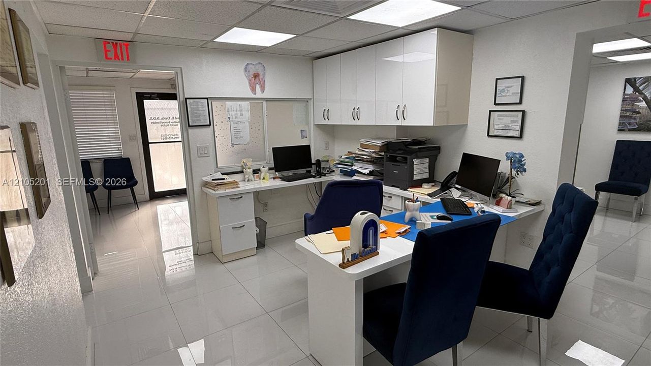 Recessed lighting, built-in white cabinetry, white walls, and white tile flooring