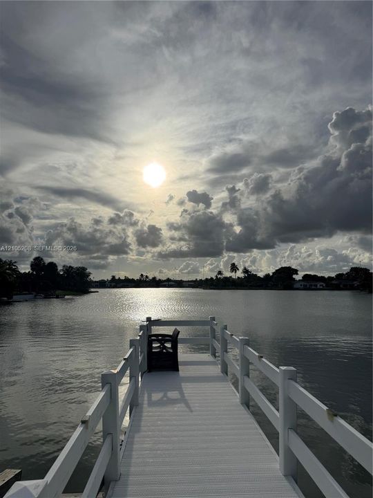 Private dock with white railings, offering direct water access