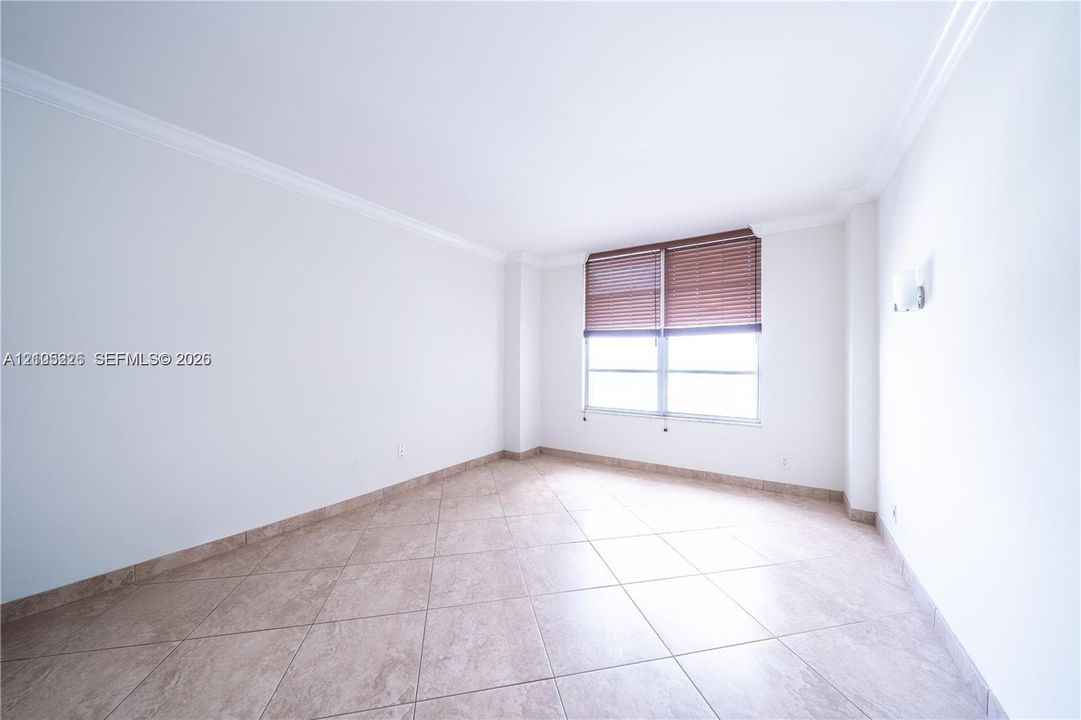 Tile flooring, crown molding, and window with built-in blinds