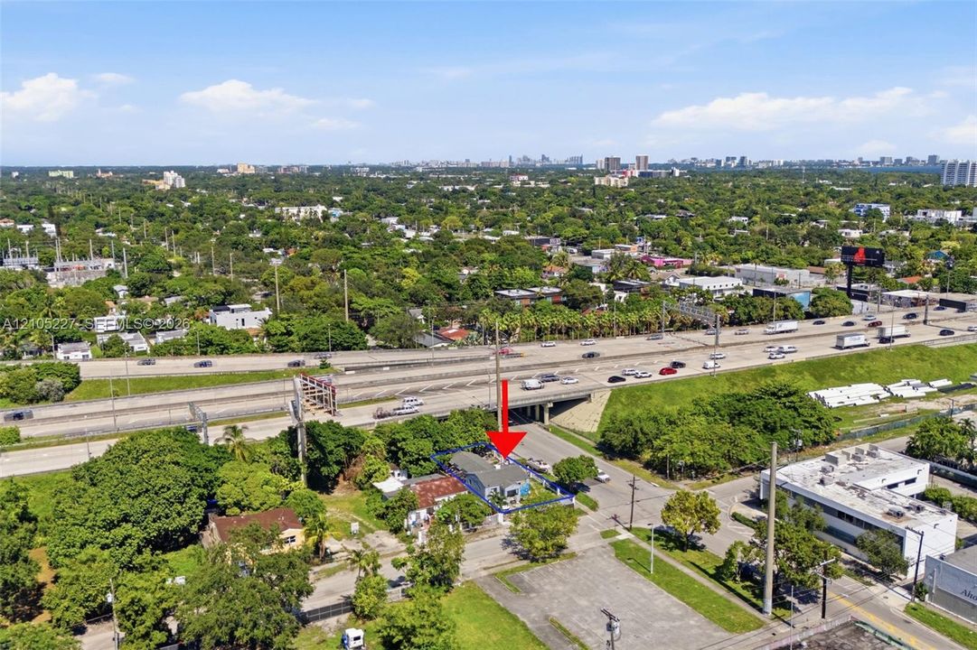 Aerial perspective of a detached single-story residence situated on a corner lot featuring a fenced perimeter