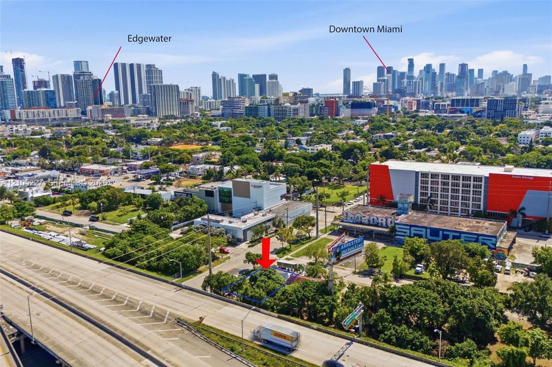 Aerial perspective of a lot featuring mature trees and proximity to the Edgewater and Downtown Miami skylines