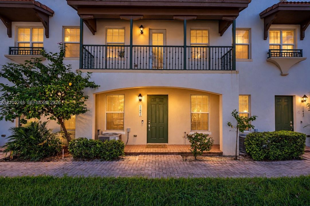 Stucco exterior with a tiled roof accent -Virtual Twilight