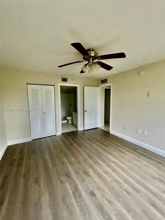 Wood-finish flooring throughout, paired with a ceiling fan light fixture