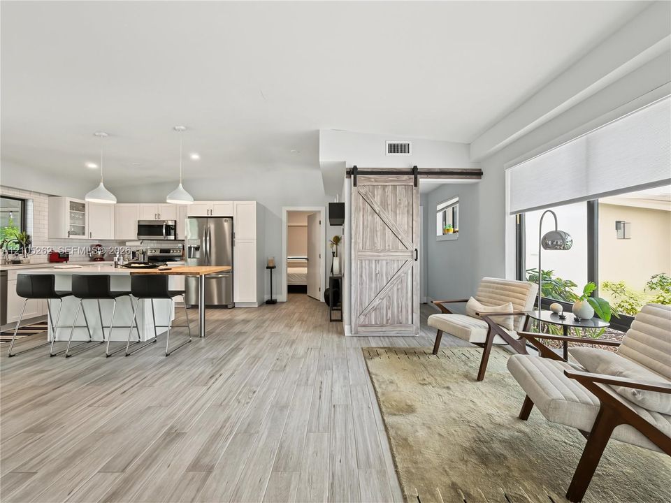 Open-concept living space with wood-finish flooring