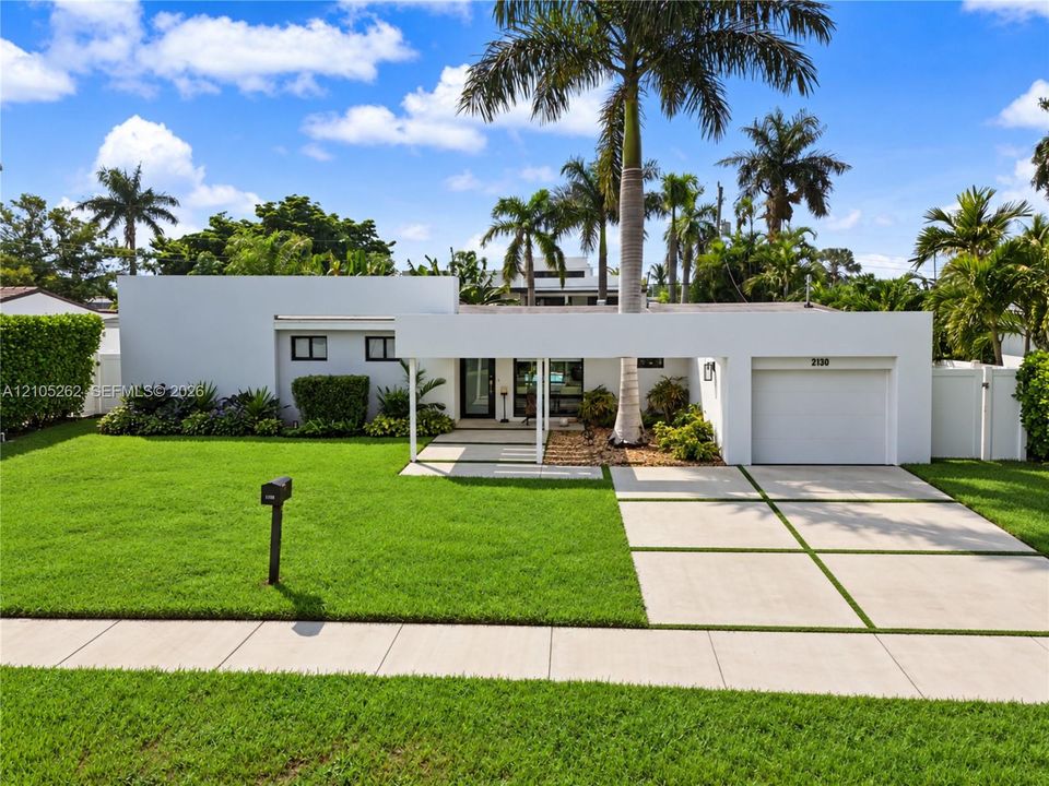 Modern exterior architecture with a flat roofline, integrated single-car garage, and a covered entryway