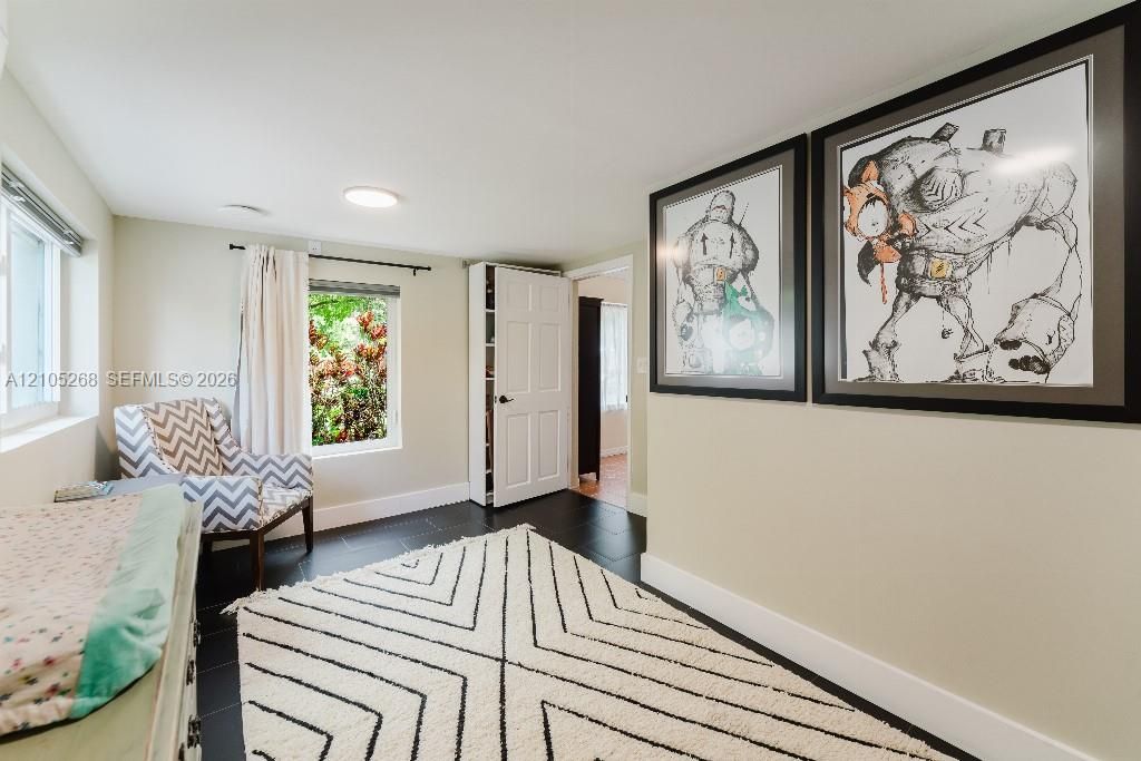 Recessed ceiling lighting, dark wood-finish flooring, and white interior doors