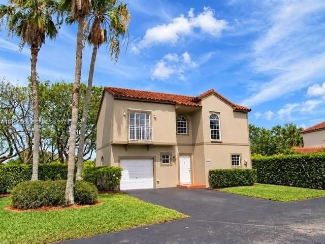 Stucco exterior with a terra cotta tile roof
