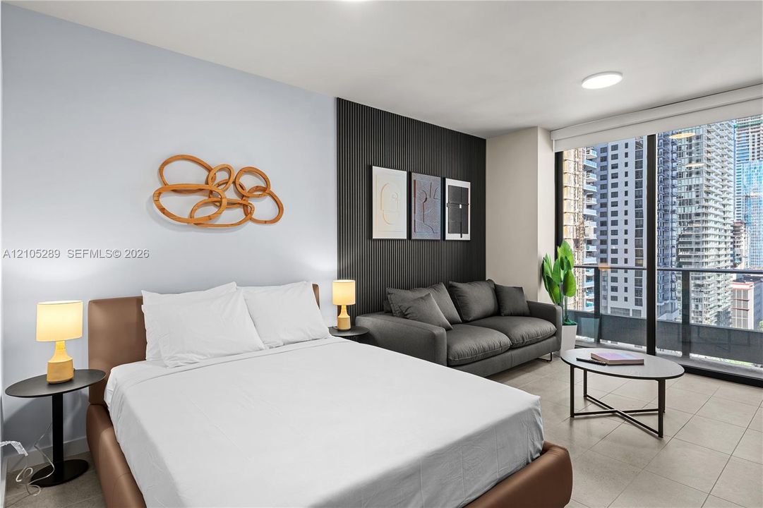 Floor-to-ceiling windows, balcony access, and tile flooring