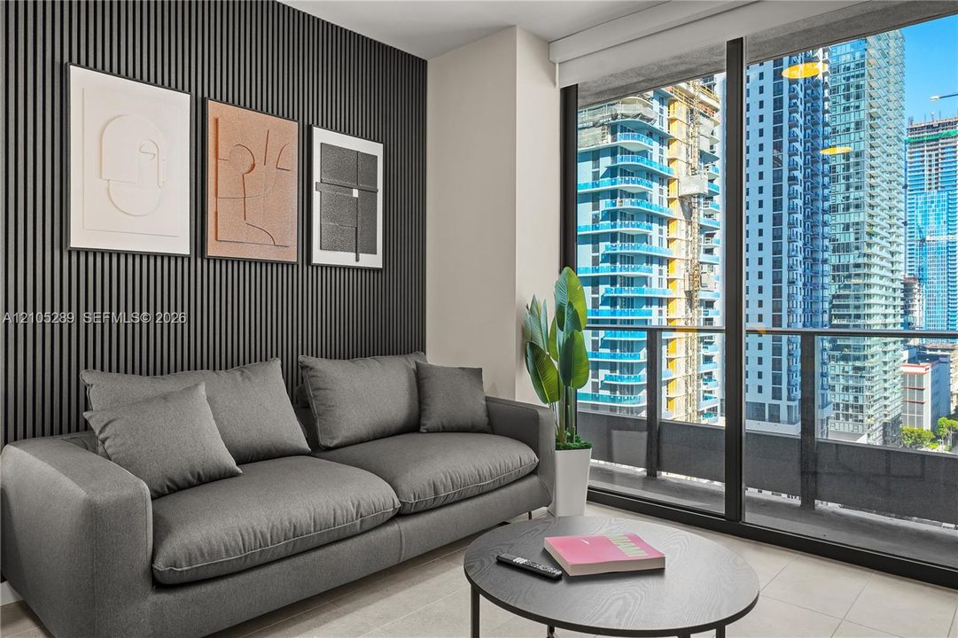Floor-to-ceiling glass doors, private balcony, city skyline backdrop, modern slat wall paneling, light-toned flooring