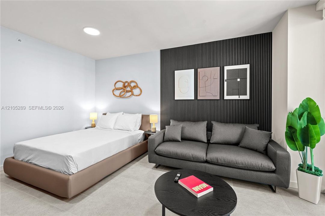 Recessed ceiling lighting complements the black slatted accent wall