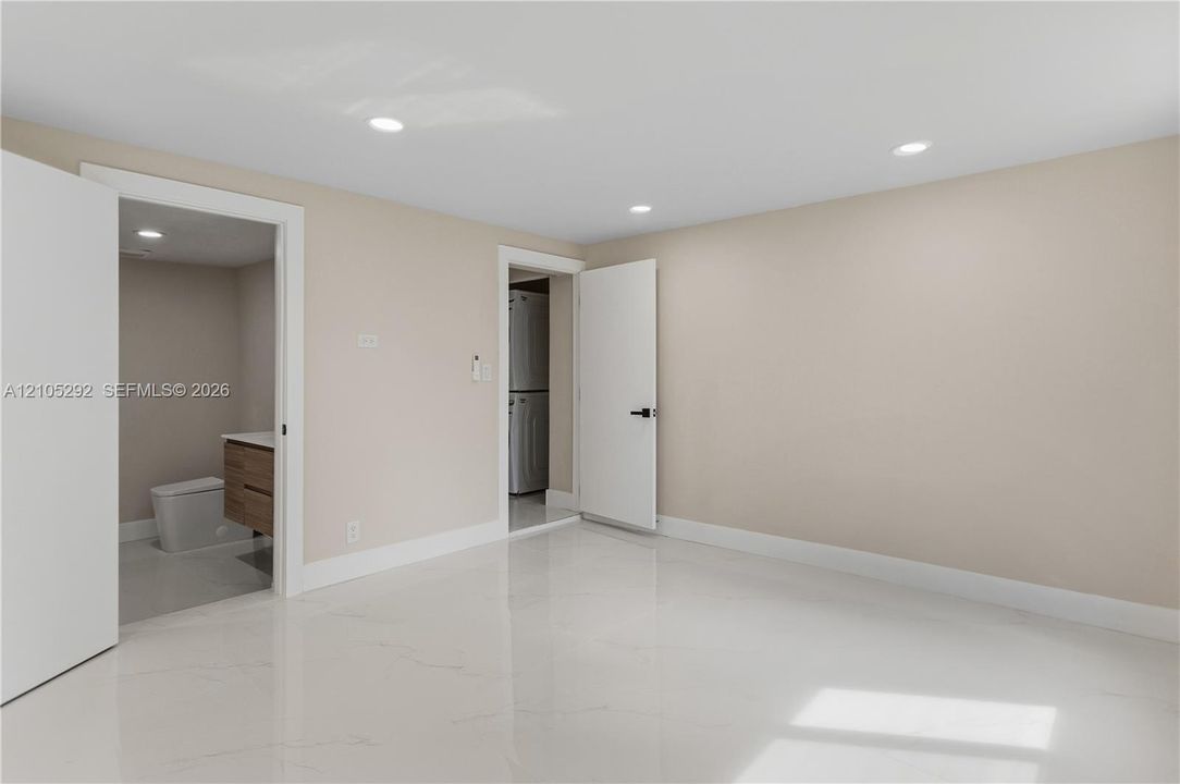 Polished tile flooring, recessed lighting, and a neutral wall color
