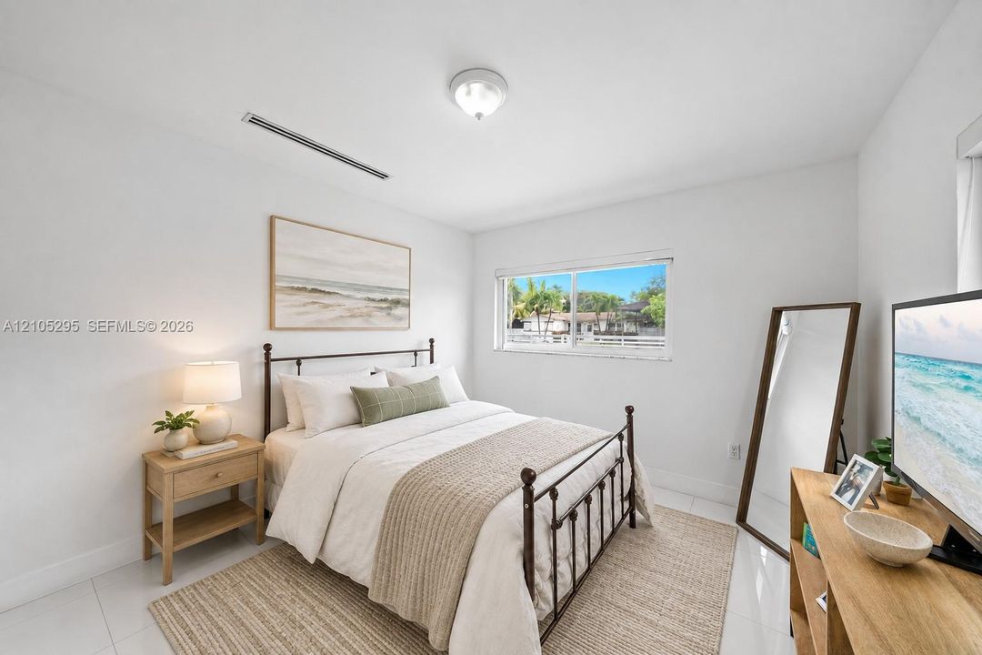 Bright interior space featuring polished tile flooring, a horizontal sliding window, and a central ceiling-mounted light fixture