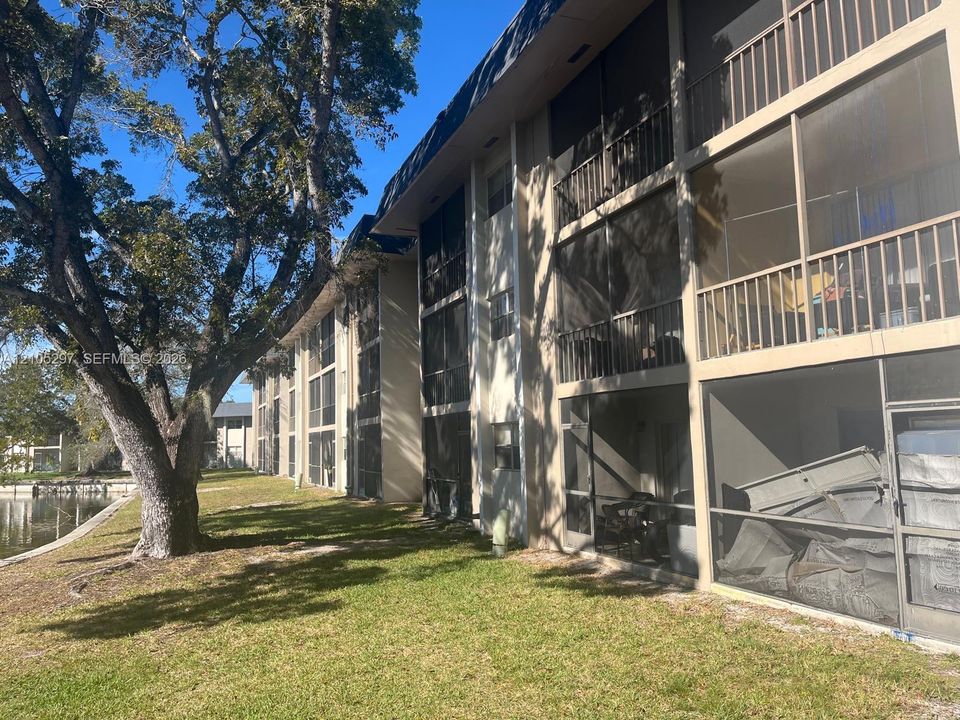 Screened balconies, mature tree landscaping, and a waterfront setting