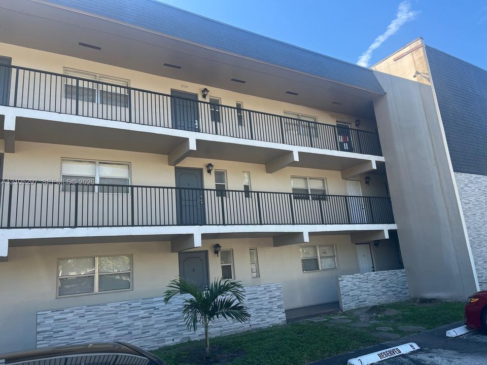 Multi-level building with individual balconies featuring black metal railings